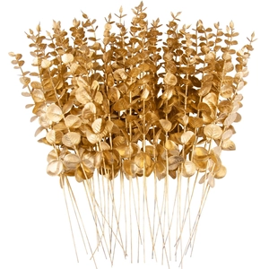 Close-up of artificial golden eucalyptus leaves with realistic metallic finish stems