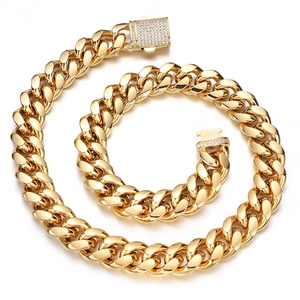 Macro view of gold Cuban link chain featuring a sparkling diamond-encrusted square clasp