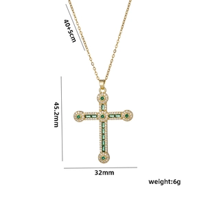 Gold hip hop cross necklace with green crystals and dimension markings on white background