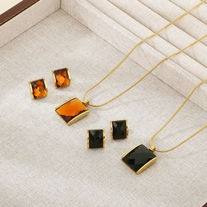 Detail of luxury snake chain necklace and square glass stone earring sets in gold finish