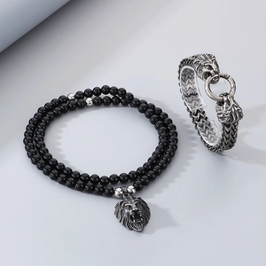 Detail of vintage lion head bracelet set with black onyx beads and stainless steel chains