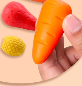 Close-up of cute giant fruit erasers including strawberry and carrot being held by hand