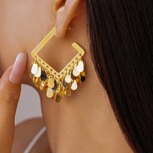 Close-up of 18K gold plated square earrings with hanging teardrop sequins on model
