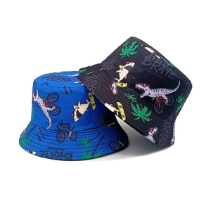 Kids reversible bucket hats featuring cartoon dinosaur and shark prints in blue and black