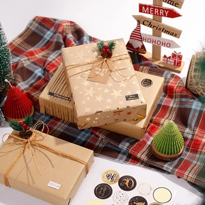Christmas kraft wrapping paper set with gold stars, jute twine, and festive decorations