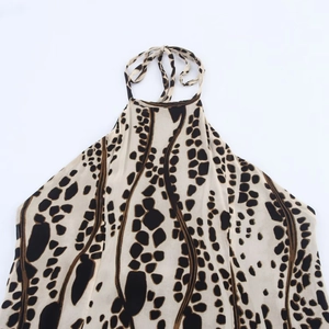 Elegant halter neck dress featuring animal print giraffe pattern on lightweight chiffon fabric