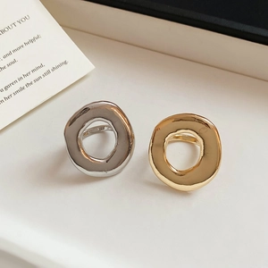 Close-up of gold and silver irregular liquid metal rings with hammered texture
