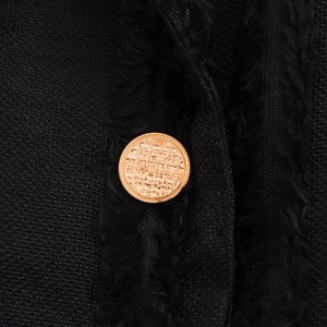 Women's long double-breasted black wool coat with detailed gold buttons and textured fabric