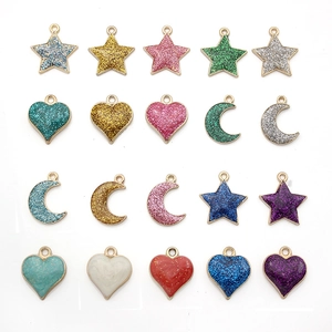 Macro shot of assorted metal glitter and marble heart charms for DIY jewelry making