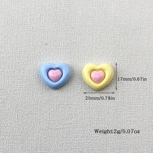 Macro shot of 20mm heart-shaped resin charms with precise dimensions and weight details