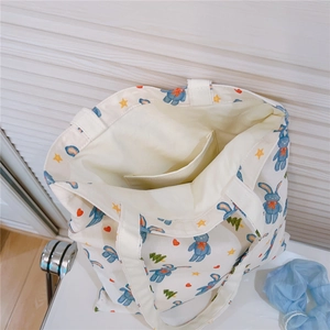 Detail view of cotton tote bag interior with small pocket and cute rabbit print