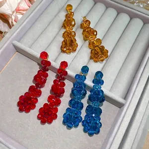 Three pairs of elegant crystal flower tassel earrings in amber, red and blue colors