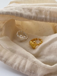 Detail view of 925 sterling silver heart rings with beaded bands in gold and silver