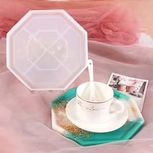Detail of octagonal silicone mold with emerald green gold leaf resin tray on pink gauze