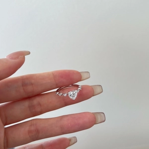 Close-up of S925 sterling silver ring featuring a heart-shaped pink zircon on a finger