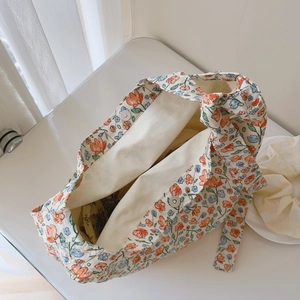 Macro view of floral canvas bag showing magnetic closure and interior lining detail