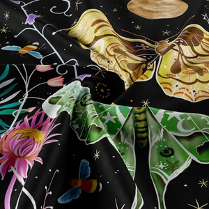 Close-up of bohemian tapestry fabric with moth, flower, and golden moon pattern