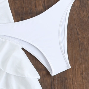 Detailed macro view of white bikini fabric with elegant ruffled edges and reinforced stitching