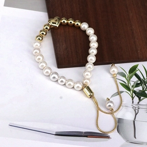 Adjustable gold heart pendant bracelet with white pearls and beaded chain for women