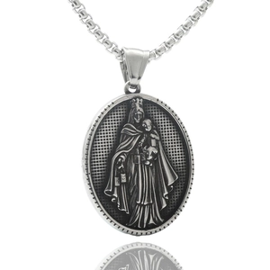 Macro detail of silver oval pendant with religious figure relief and metal chain