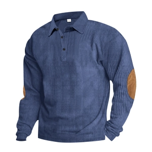 Detail of blue corduroy polo shirt featuring brown suede elbow patches and high texture