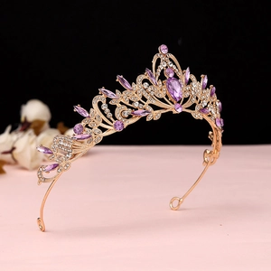 Detailed close-up of Baroque vintage gold tiara featuring purple gemstones and sparkling crystals