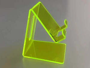 Macro detail of fluorescent yellow acrylic phone stand with sleek transparent finish