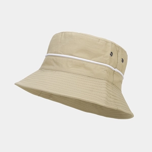 Close-up of beige waterproof bucket hat with white trim and metal eyelets for ventilation