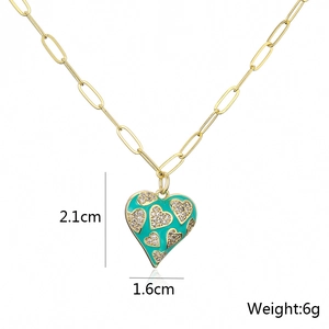 Detail showing 2.1cm turquoise heart pendant with gold chain and small diamond pattern
