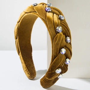 Detail of yellow velvet braided headband with sparkling rhinestones in a retro style