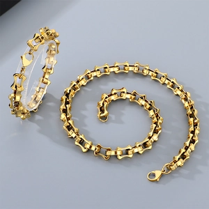 Macro shot of gold bamboo link jewelry set featuring titanium steel necklace and bracelet