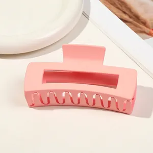 Minimalist matte pink rectangular large hair claw clip on white background for styling
