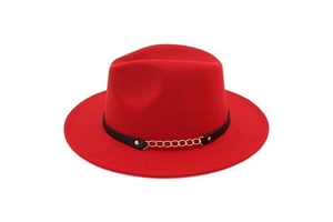 Detail view of red felt fedora with a black leather band and gold chain accent