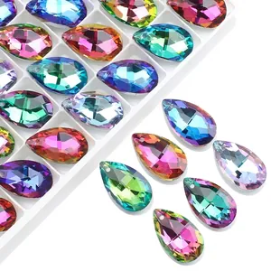 Macro detail of faceted teardrop crystal beads in vibrant gradient colors with pre-drilled holes