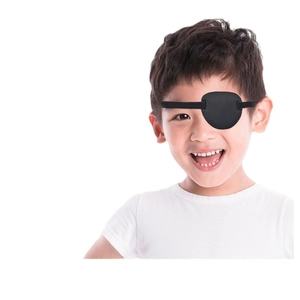 Smiling boy wearing a black single eye patch with elastic band for vision correction training