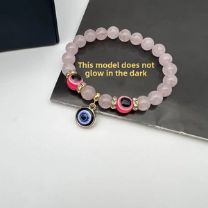 Detail of pink crystal evil eye beaded bracelet with gold spacers and non-luminous beads