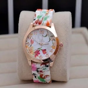 Detail of rose gold ladies quartz watch with floral patterns on dial and band