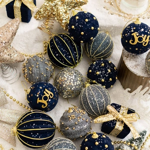 Blue and gold velvet Christmas ornaments set with glitter stars on snow background
