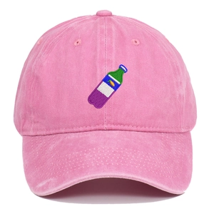 Close-up of pink washed cotton baseball cap featuring unique bottle embroidery detail