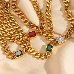 Macro detail of gold-plated Cuban chain necklaces with colorful rectangular zircon pendants