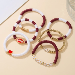 Detail of burgundy and white clay bead bracelets with football charms and Game Day text