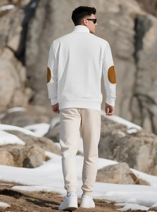 Men's white knit sweater with stand collar, zipper, and brown elbow patches in snowy setting