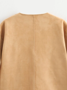 Detailed view of camel suede flight jacket showing back seam and premium matte texture
