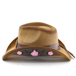 Detail of light brown western cowboy straw hat with pink rose embroidery and leather band