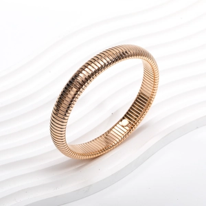Modern rose gold elastic bracelet featuring a minimalist textured ripple metal design