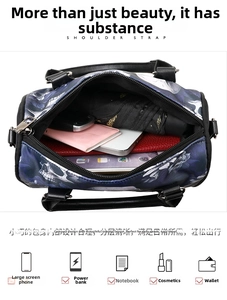 Spacious interior of skull print Boston bag holding umbrella, phone, and wallet