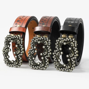 Three punk style leather belts with star embossing and ornate gold studded buckles