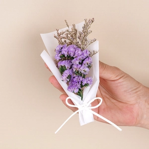 Mini dried purple baby's breath flower bouquet with white gift wrap and ribbon bow