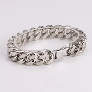 Macro side view of a classic silver stainless steel Cuban link bracelet with a secure clasp
