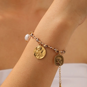 Bohemian woven rope bracelet with gold embossed floral charms and white pearls